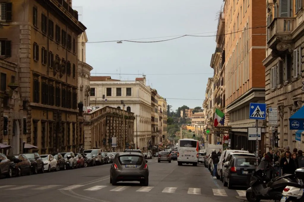 A quiet cobbled lane at dusk — two streets off any main square, prices drop and sleep improves